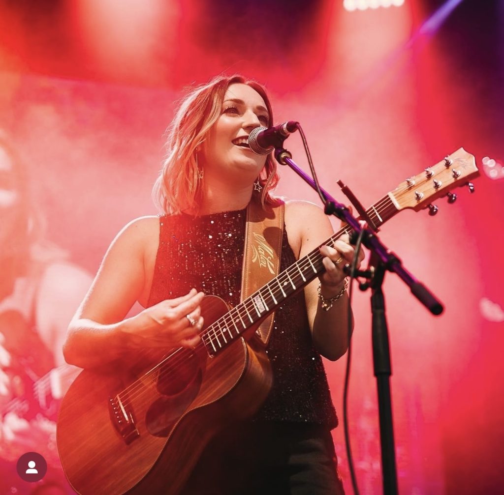 jesse playing guitar on stage